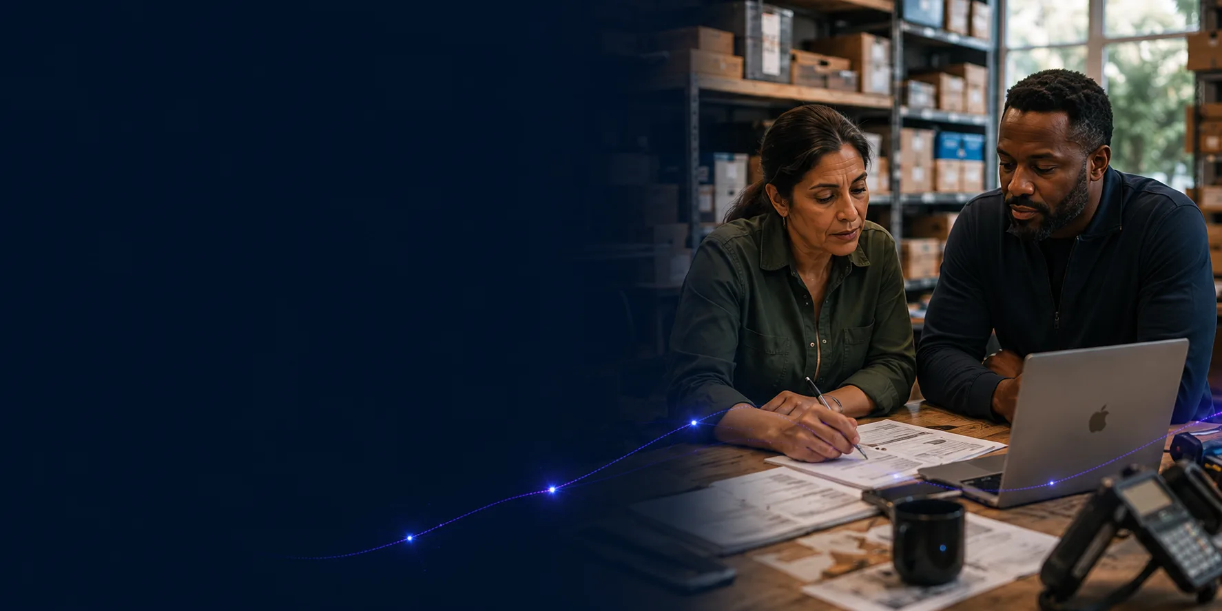 Owner and adviser reviewing sales, process and commercial priorities in a practical business workspace